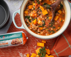 A pot of fall harvest soup with butternut squash, Isernio's ground chicken sausage and tomatoes.