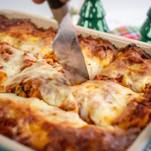 Lasagna made with Isernio pork sausage in a large pan set at a festive holiday table