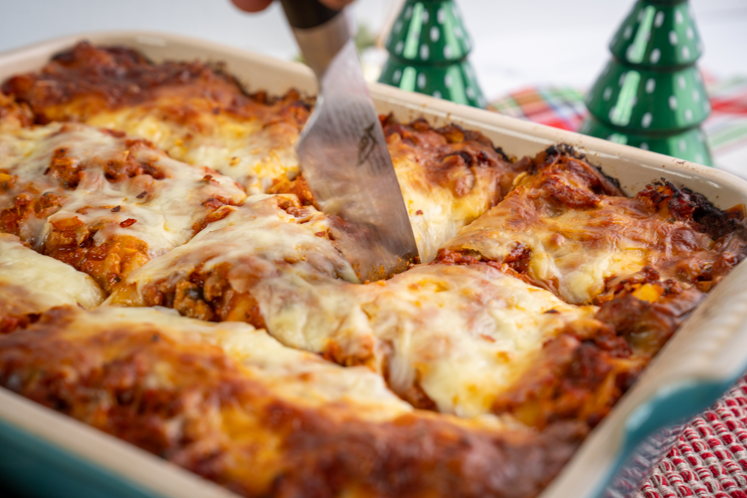 Lasagna made with Isernio pork sausage in a large pan set at a festive holiday table