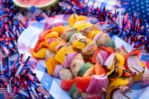 Backyard BBQ with grilled kebabs and chicken sausage