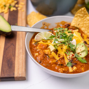 Bowl of ground chicken and tortilla soup.