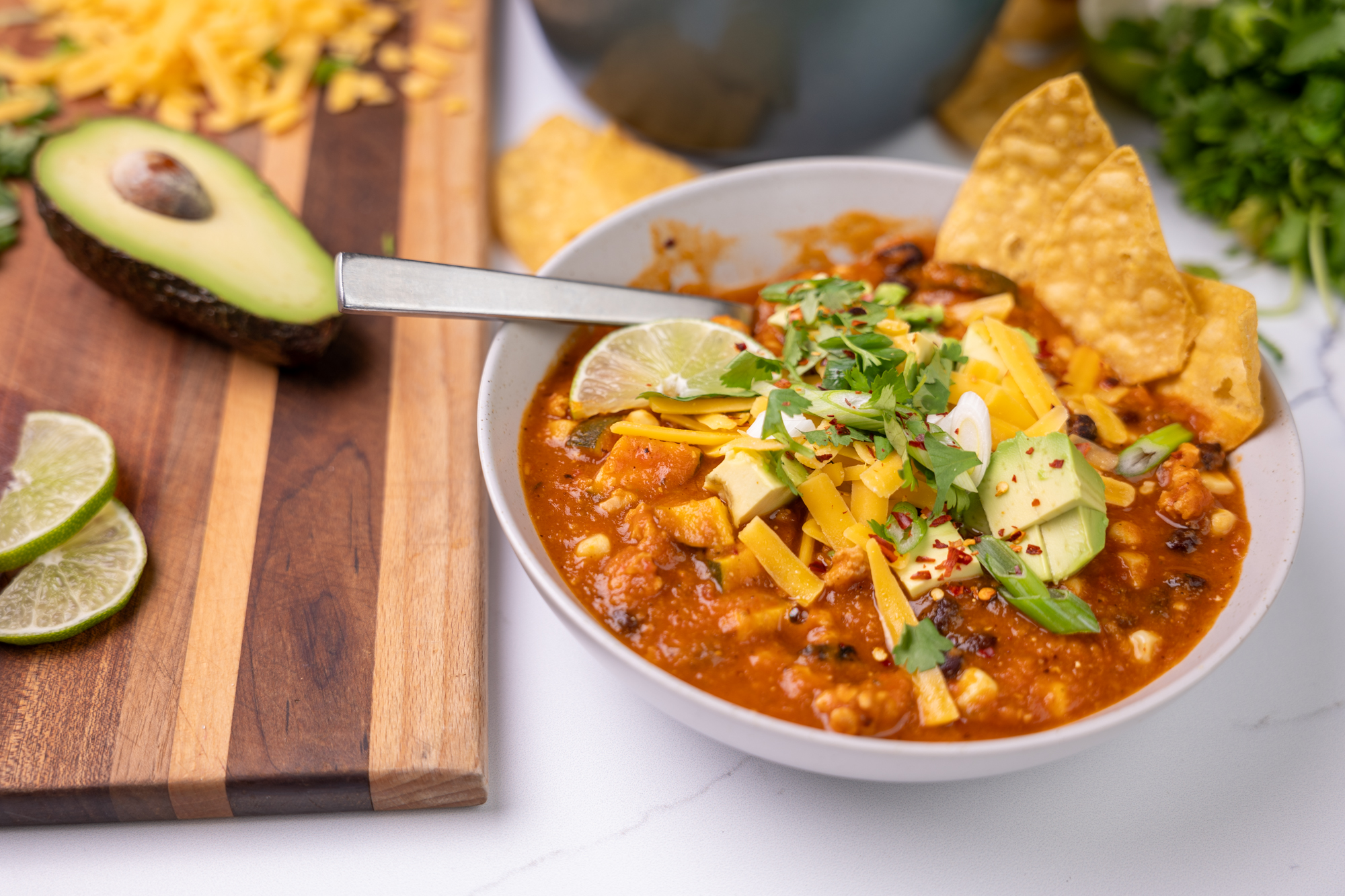 Bowl of ground chicken and tortilla soup.