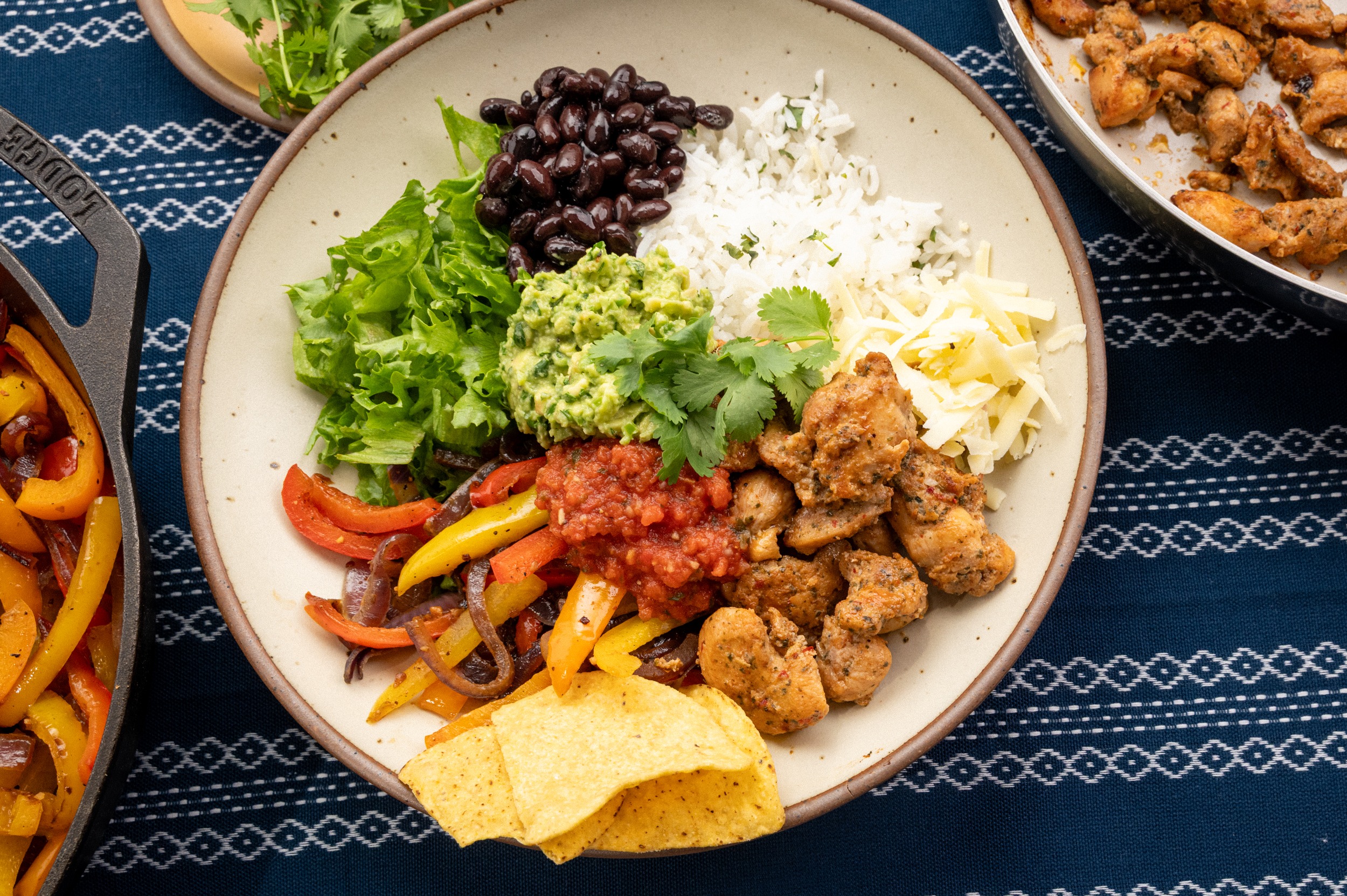 Isernio’s Chipotle Lime Chicken Burrito Bowl with cilantro lime rice, black beans, sautéed peppers and onions, lettuce, guacamole, salsa, shredded cheese, cilantro and tortilla chips.